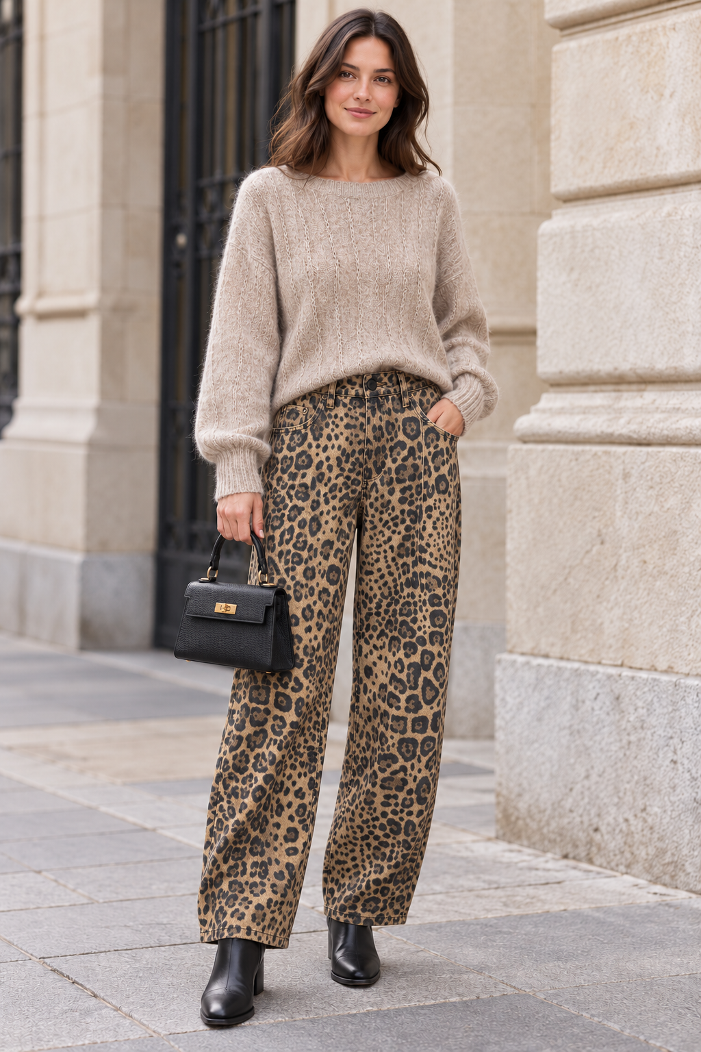 Jersey beige con pantalón recto de leopardo y bolso negro de mano